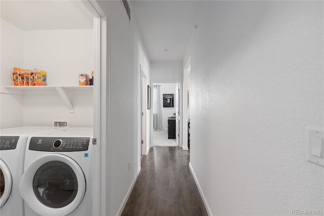 laundry room featuring washer and dryer, dark wood-style flooring, laundry area, and baseboards