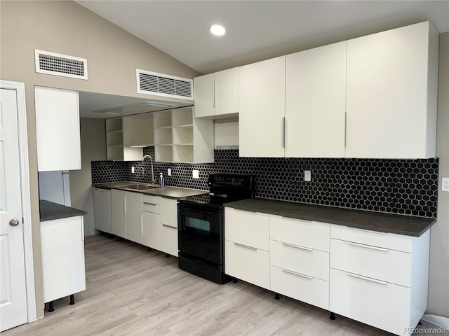 3414 S Locust St Unit D, Denver, CO 80222 - kitchen featuring black range with electric cooktop, dark countertops, white dishwasher, decorative backsplash, and vaulted ceiling