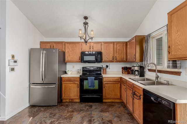 kitchen with an inviting chandelier, a sink, black appliances, light countertops, and decorative light fixtures