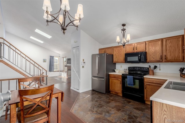 kitchen featuring light countertops, lofted ceiling, brown cabinets, a notable chandelier, and black appliances