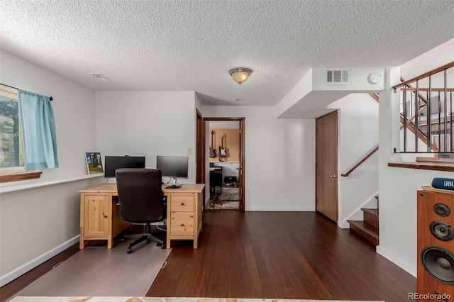 office with visible vents, a textured ceiling, dark wood-type flooring, and baseboards