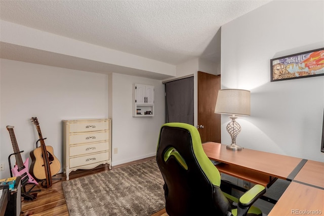 home office featuring a textured ceiling and wood finished floors