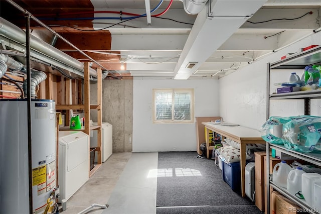 basement with visible vents, independent washer and dryer, and water heater