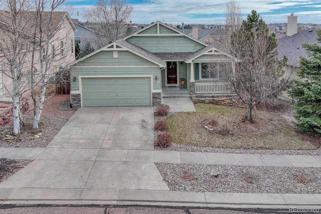 craftsman-style home featuring covered porch and a garage