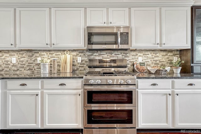 kitchen with decorative backsplash, appliances with stainless steel finishes, and white cabinetry