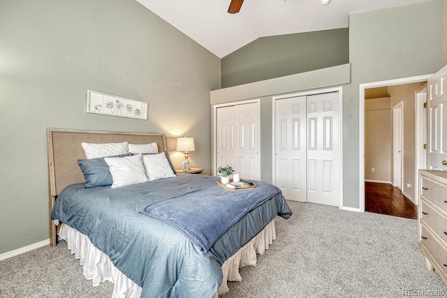 carpeted bedroom featuring multiple closets, ceiling fan, and lofted ceiling