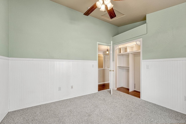 unfurnished bedroom with carpet, ceiling fan, and a closet