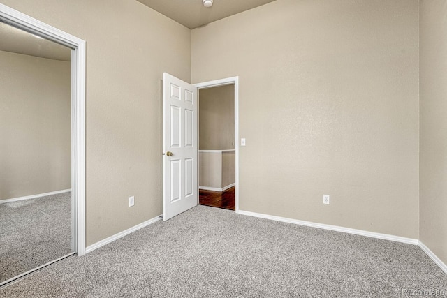 unfurnished bedroom with carpet flooring and a closet