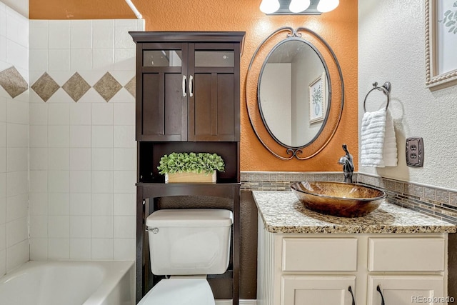 full bathroom featuring vanity, toilet, and tiled shower / bath combo