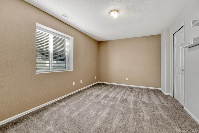 unfurnished bedroom with light carpet and a textured ceiling