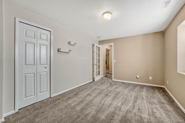 unfurnished bedroom featuring light carpet and a closet