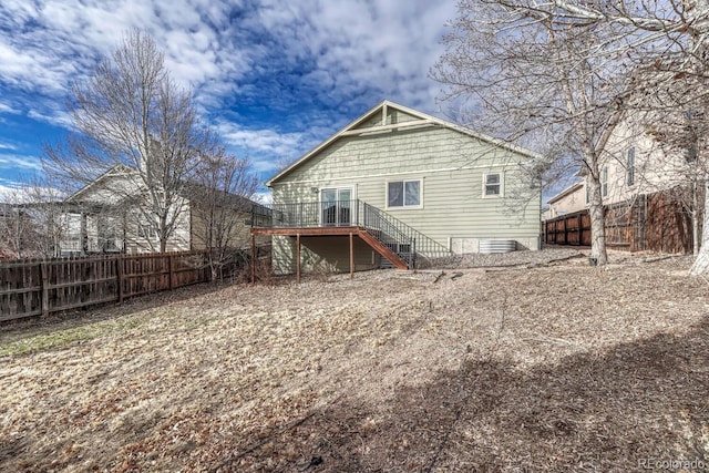 back of property featuring a wooden deck