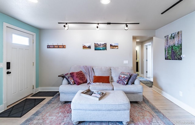 living room featuring track lighting and wood-type flooring