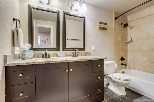 full bath with toilet, tile patterned flooring, double vanity, and a sink