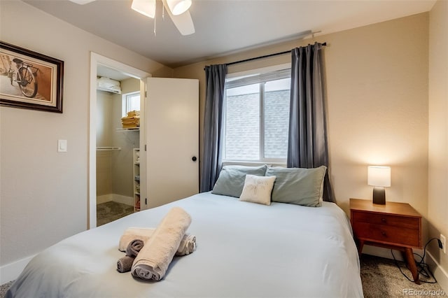 carpeted bedroom with ceiling fan and baseboards