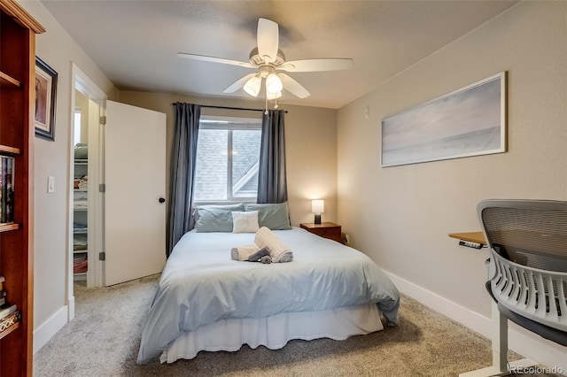 carpeted bedroom featuring a ceiling fan and baseboards