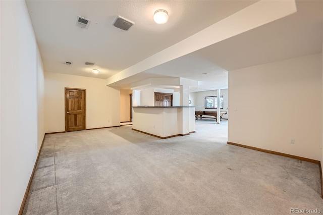 unfurnished living room featuring light carpet