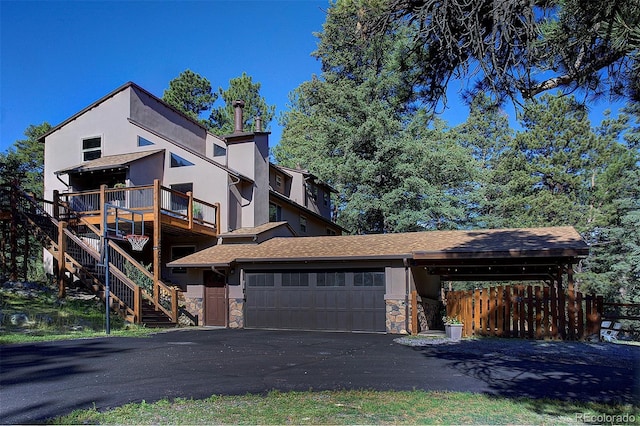 28051 Camel Heights Cir, Evergreen, CO 80439 - view of front of property with a garage, stairs, driveway, stucco siding, and a shingled roof