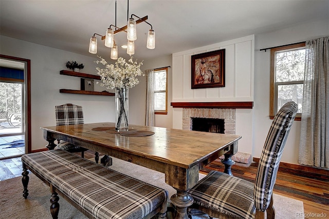 28051 Camel Heights Cir, Evergreen, CO 80439 - dining area featuring wood finished floors and a fireplace