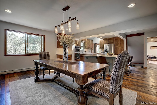 28051 Camel Heights Cir, Evergreen, CO 80439 - dining room with a baseboard radiator, plenty of natural light, dark wood-style flooring, and recessed lighting