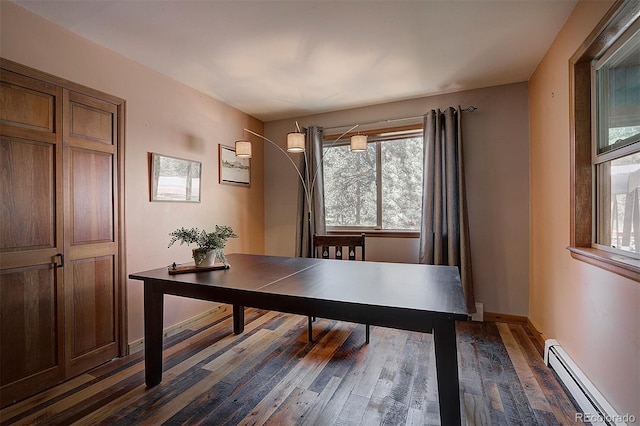 28051 Camel Heights Cir, Evergreen, CO 80439 - home office with baseboard heating, dark wood-type flooring, and healthy amount of natural light