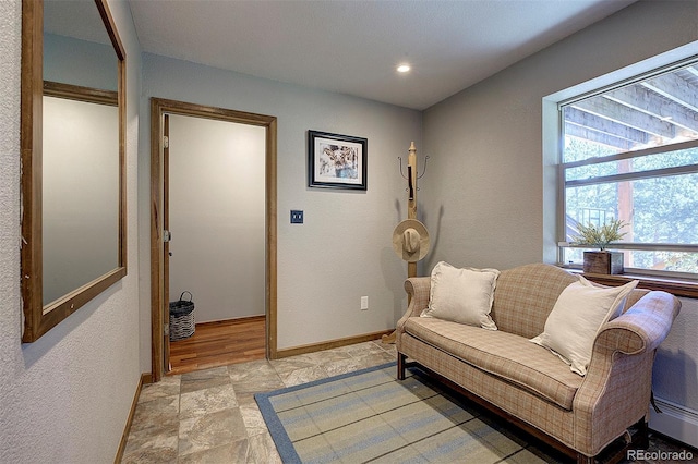28051 Camel Heights Cir, Evergreen, CO 80439 - living area with light stone finish floors, a baseboard heating unit, and recessed lighting