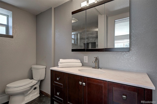 28051 Camel Heights Cir, Evergreen, CO 80439 - full bath featuring a textured wall, plenty of natural light, vanity, and a stall shower