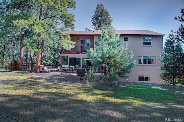 28051 Camel Heights Cir, Evergreen, CO 80439 - rear view of house featuring a balcony, stucco siding, a patio, and an outdoor living space