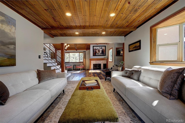 28051 Camel Heights Cir, Evergreen, CO 80439 - living room with a wood ceiling with exposed beams, wood finished floors, recessed lighting, stairway, and a fireplace with raised hearth