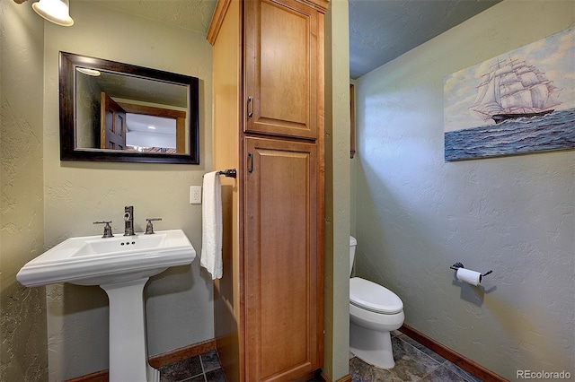 28051 Camel Heights Cir, Evergreen, CO 80439 - half bath with toilet and tile patterned floors