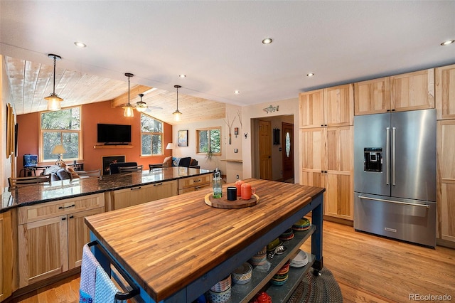kitchen featuring high end fridge, light brown cabinetry, ceiling fan, light wood finished floors, and open floor plan