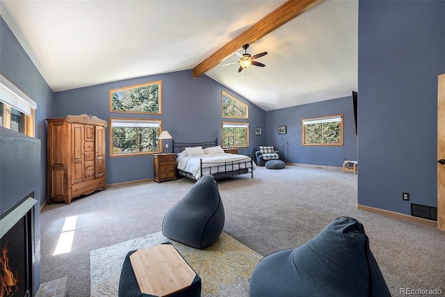 bedroom featuring carpet flooring, a ceiling fan, and a lit fireplace