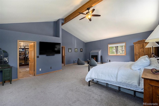 bedroom with carpet floors, beamed ceiling, ceiling fan, a walk in closet, and high vaulted ceiling