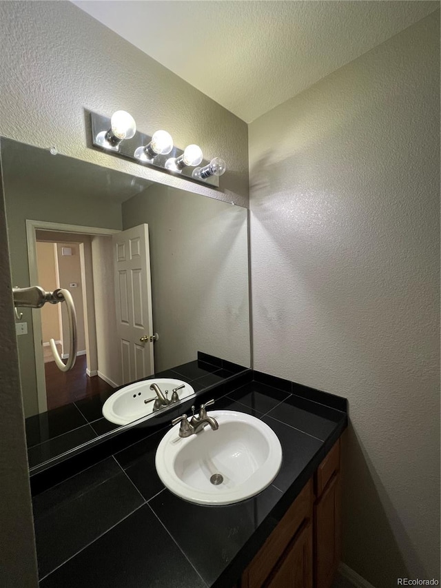 bathroom with vanity and a textured ceiling