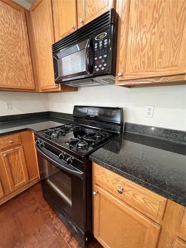 kitchen with black appliances and dark stone countertops