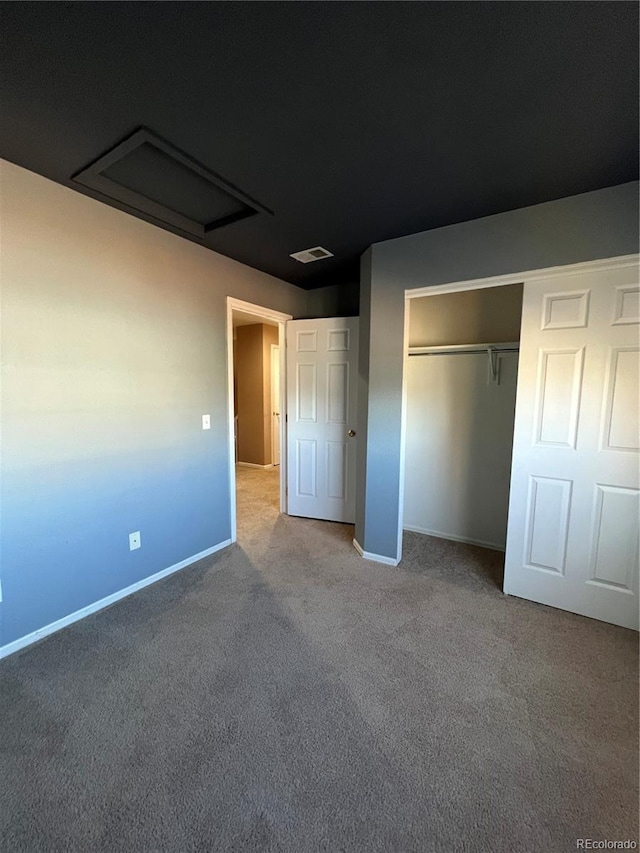 unfurnished bedroom with a closet and carpet floors