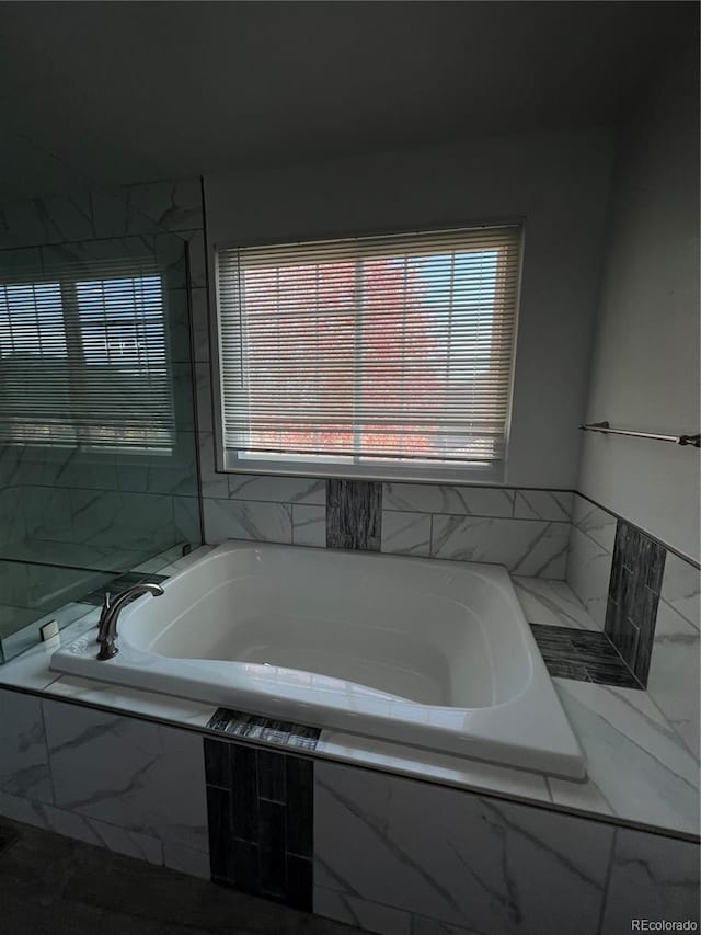 bathroom with tiled bath