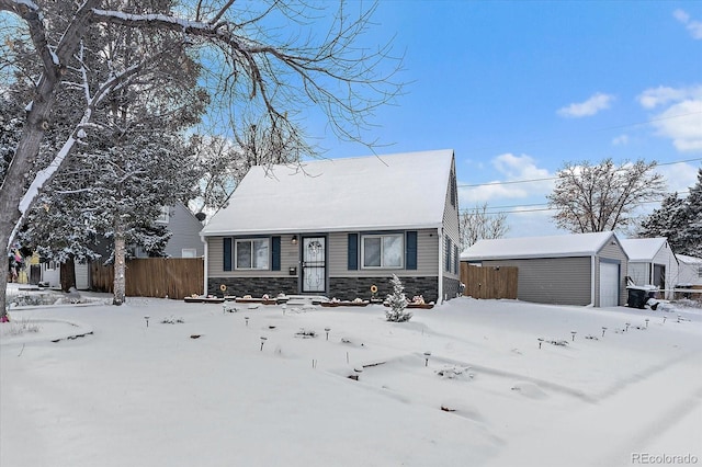 view of front of home with a garage and an outbuilding