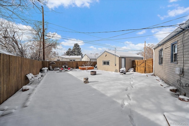 yard covered in snow with an outbuilding