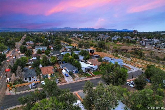 aerial view at dusk featuring a mountain view