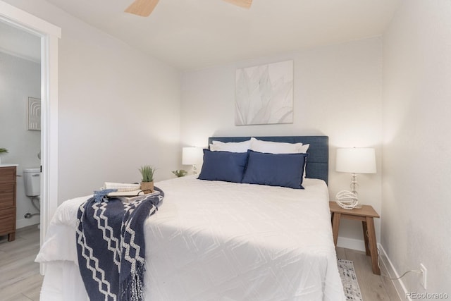 bedroom with ceiling fan, connected bathroom, and light wood-type flooring