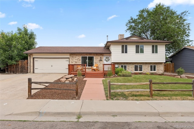 12705 W Chenango Ave, Morrison, CO 80465 - tri-level home with brick siding, concrete driveway, an attached garage, and a deck