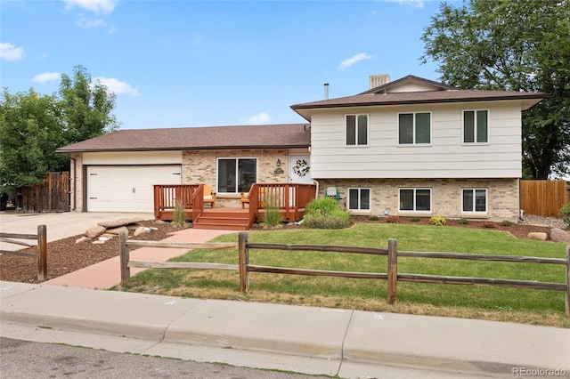 12705 W Chenango Ave, Morrison, CO 80465 - split level home featuring brick siding, driveway, a garage, and a deck
