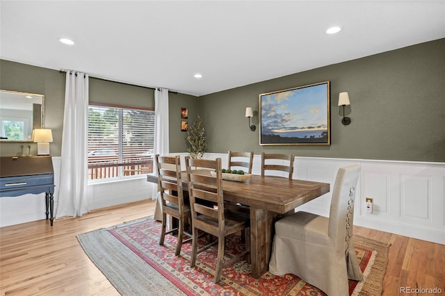 12705 W Chenango Ave, Morrison, CO 80465 - dining room with wainscoting, plenty of natural light, light wood-style flooring, recessed lighting, and a decorative wall