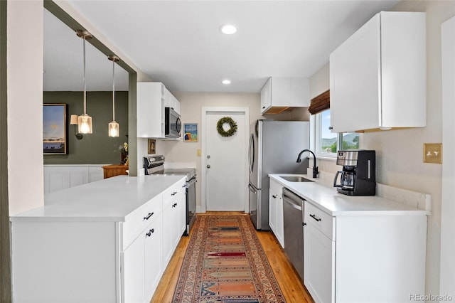 12705 W Chenango Ave, Morrison, CO 80465 - kitchen featuring stainless steel appliances, light wood-type flooring, white cabinetry, light countertops, and recessed lighting