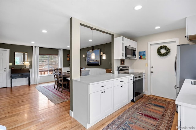 12705 W Chenango Ave, Morrison, CO 80465 - kitchen with stainless steel appliances, white cabinets, light countertops, light wood-type flooring, and recessed lighting