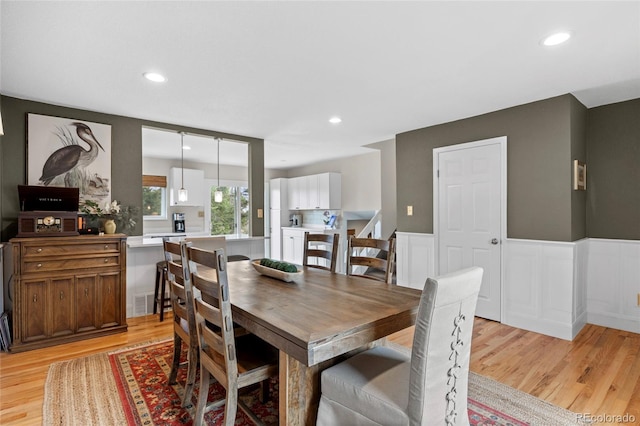 12705 W Chenango Ave, Morrison, CO 80465 - dining room featuring light wood-type flooring, wainscoting, and recessed lighting