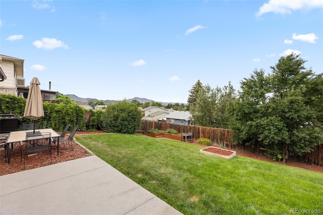 12705 W Chenango Ave, Morrison, CO 80465 - fenced backyard featuring a vegetable garden, a patio area, and a mountain view