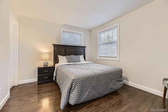 bedroom featuring dark wood finished floors and baseboards