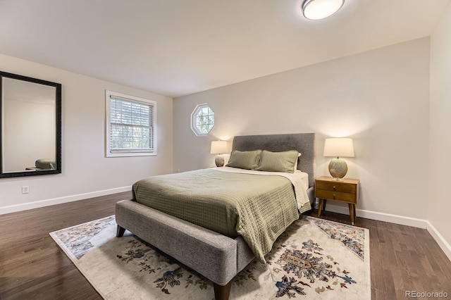 bedroom featuring baseboards and wood finished floors